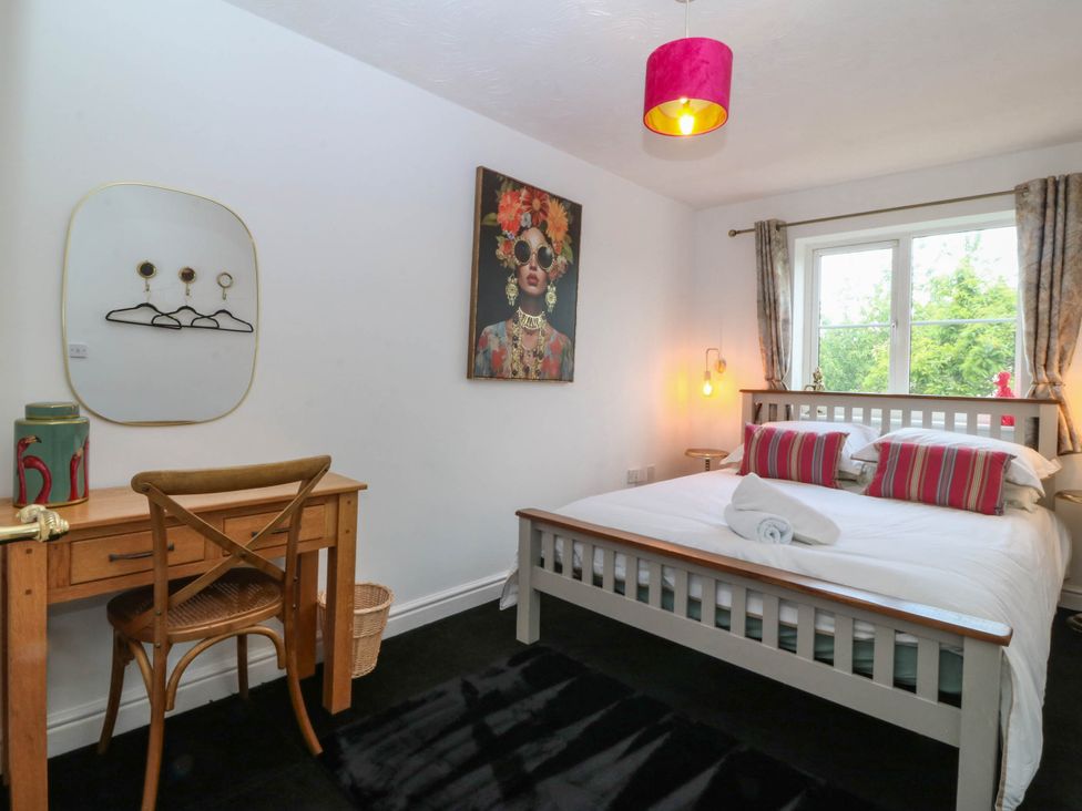 A bedroom with a bed and desk at Meadow View in Kinmel Bay