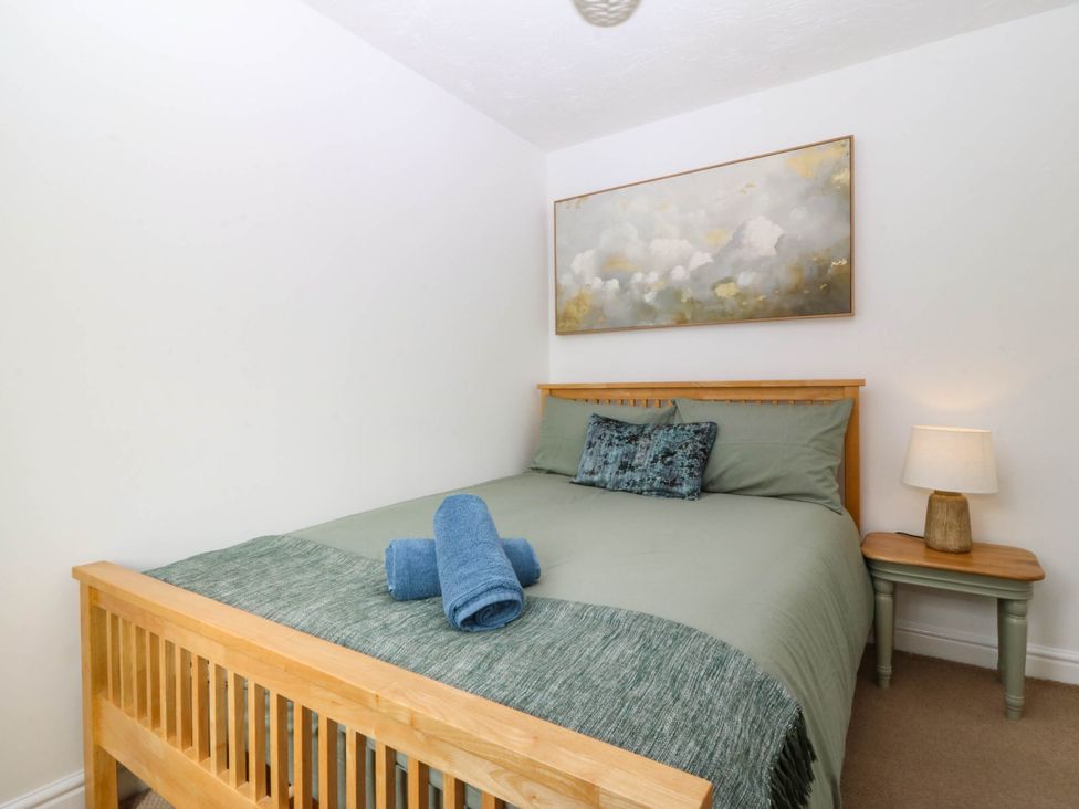 A bedroom with a bed and bedside table at Meadow View in Kinmel Bay