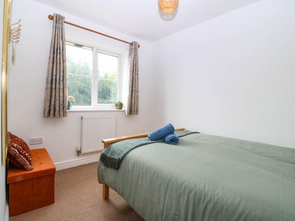 A bedroom with a bed and a window at Meadow View in Kinmel Bay