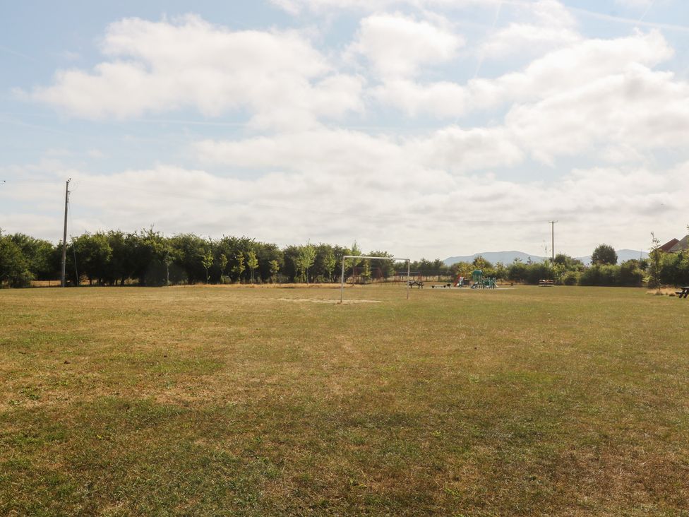 An open field with goalposts and trees at Meadow View in Kinmel Bay