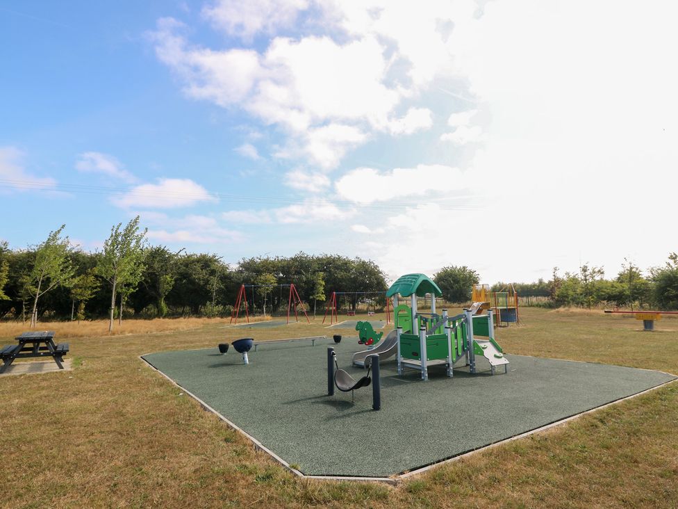 A playground with slides and swings at Meadow View in Kinmel Bay