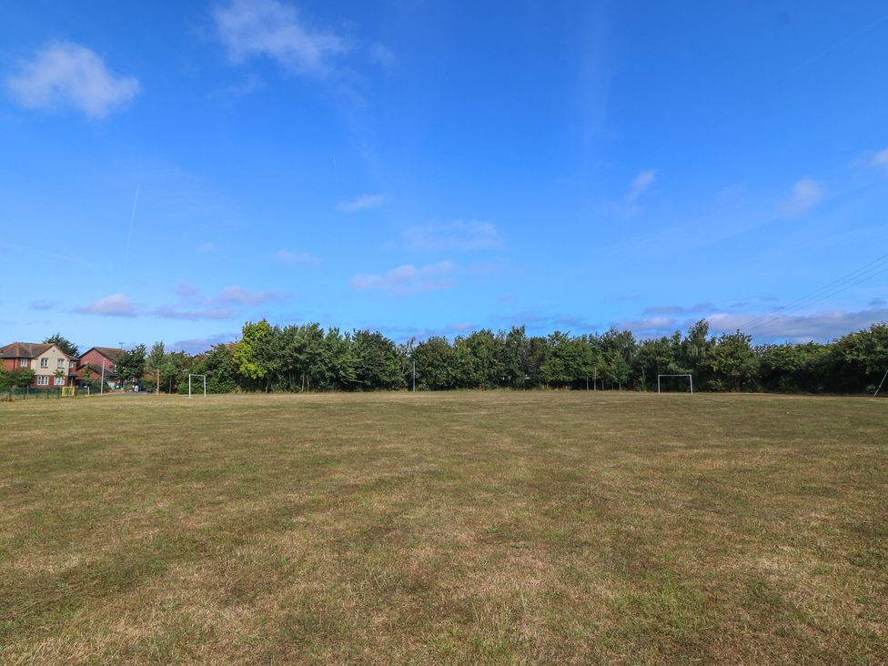 An outdoor sports field with goalposts and trees at Meadow View in Kinmel Bay
