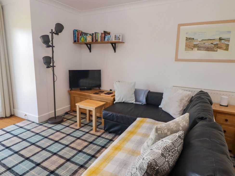 A living room with a sofa and television at Ty Mor in Newport, Pembrokeshire