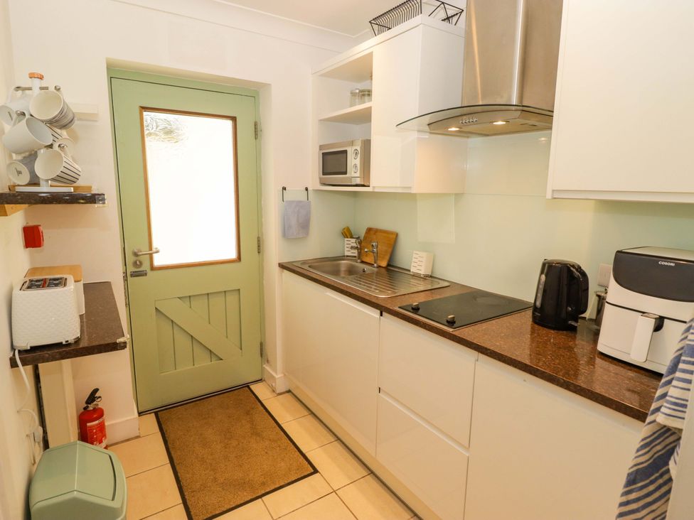 A kitchen with a sink and appliances at Ty Mor in Newport, Pembrokeshire