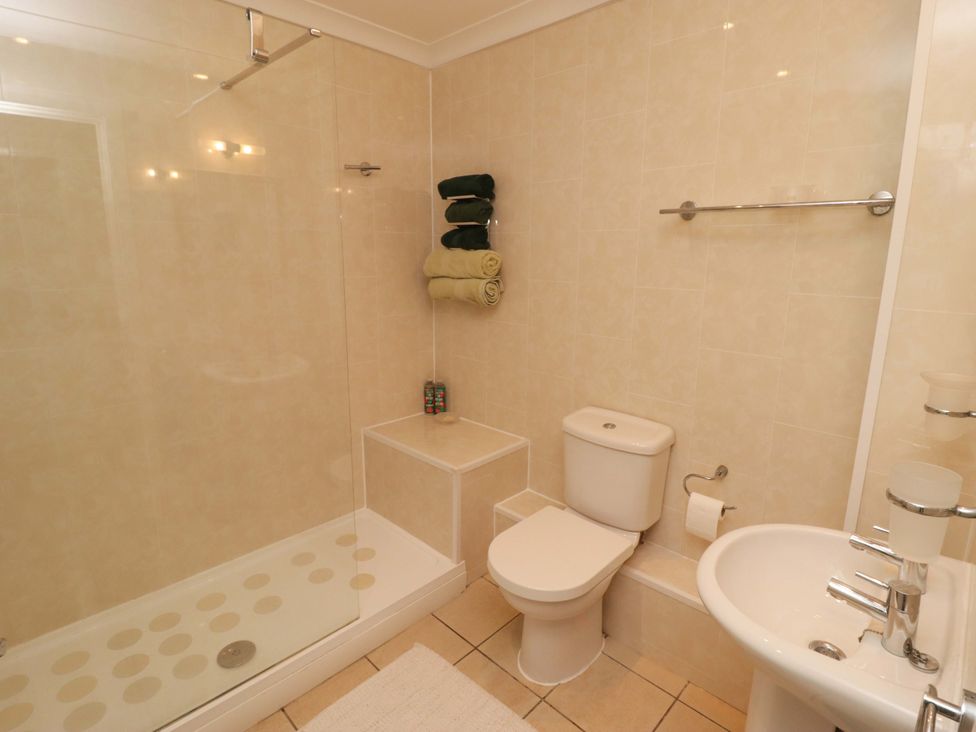 A bathroom with a shower, toilet, and sink at Ty Mor in Newport, Pembrokeshire