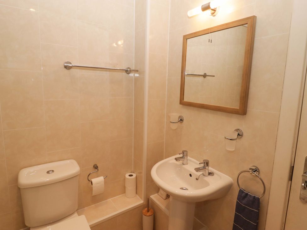 A bathroom with a toilet and washbasin at Ty Mor in Newport, Pembrokeshire