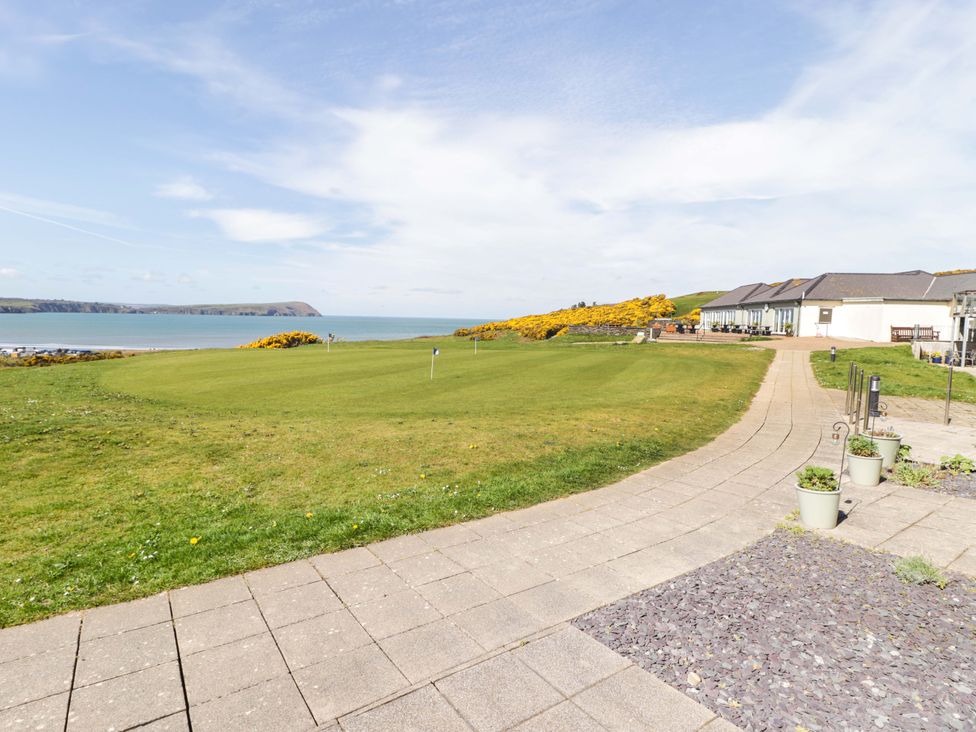 An outdoor space with grass and a pathway at Ty Mor in Newport, Pembrokeshire