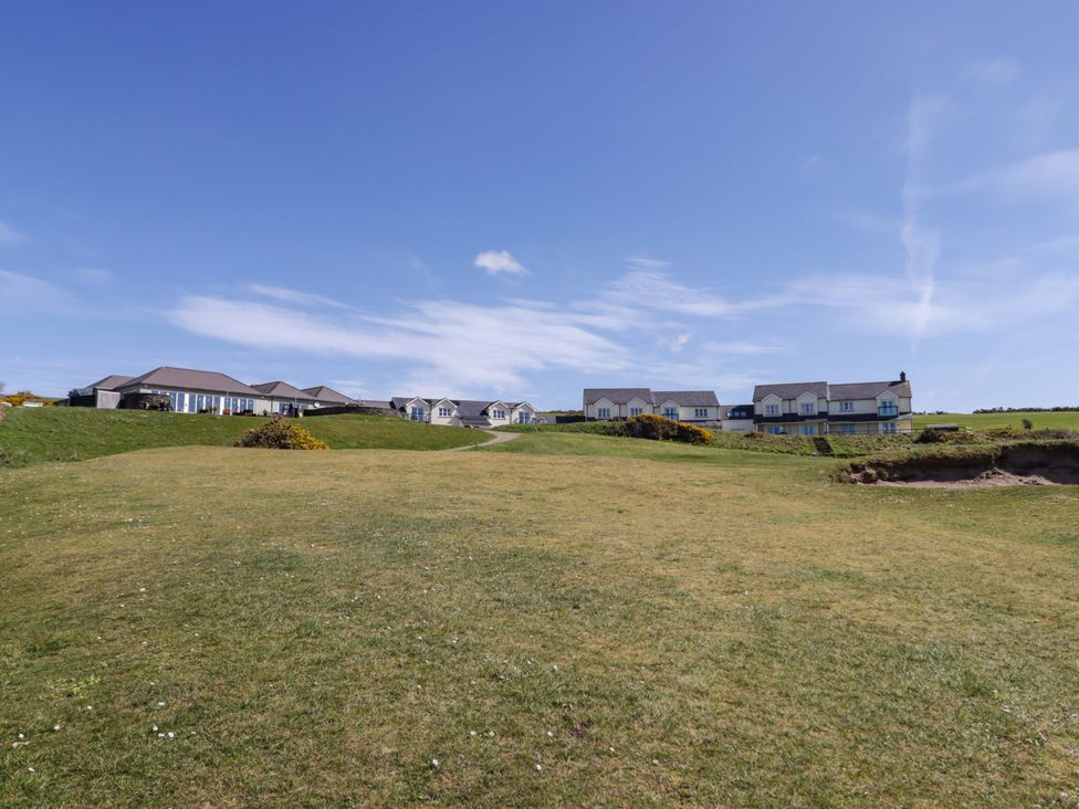 Houses on a grassy area with blue sky at Ty Mor Newport, Pembrokeshire