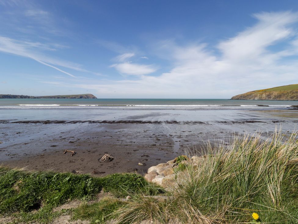 A beach scene with sand and sea at Ty Mor in Newport, Pembrokeshire