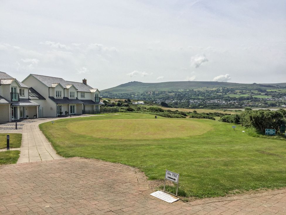 A golf area with houses and a mountain in the background at Ty Mor in Newport, Pembrokeshire
