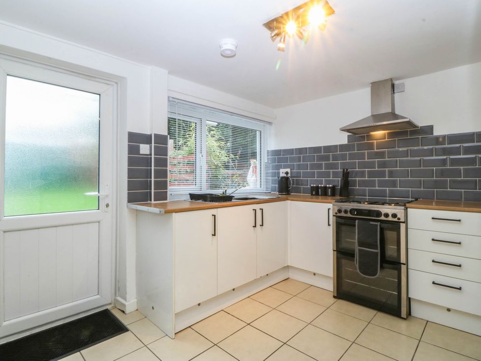 A kitchen with units and an oven at Emily Rose Cottage in Bangor