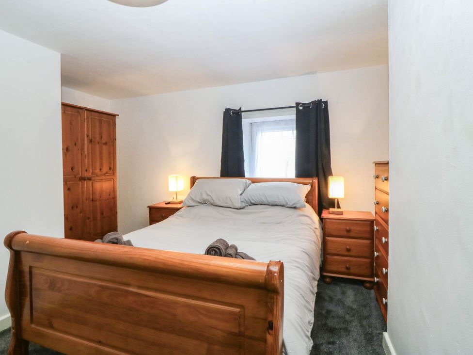 A bedroom with a bed and furniture at Emily Rose Cottage Bangor