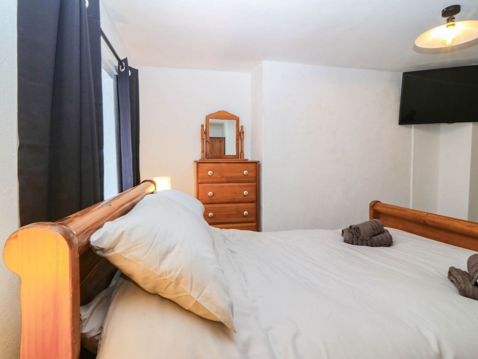 A bedroom with a bed and dresser at Emily Rose Cottage in Bangor