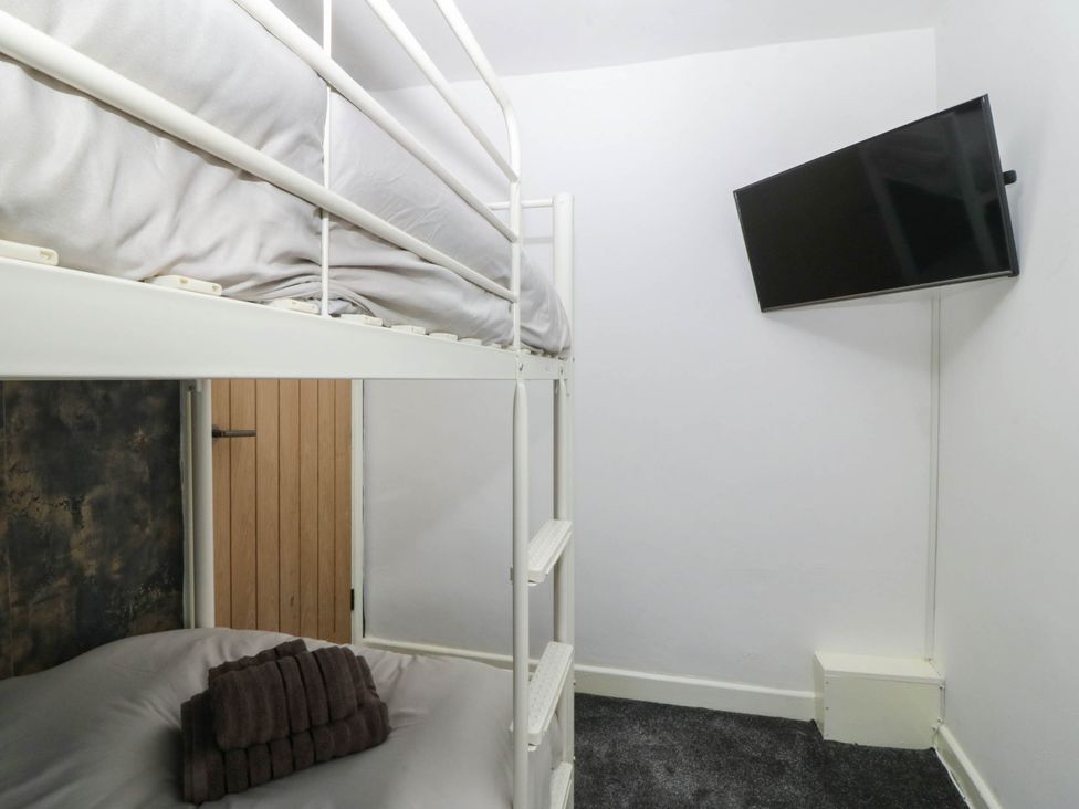 A bedroom with a bunk bed and a television at Emily Rose Cottage in Bangor