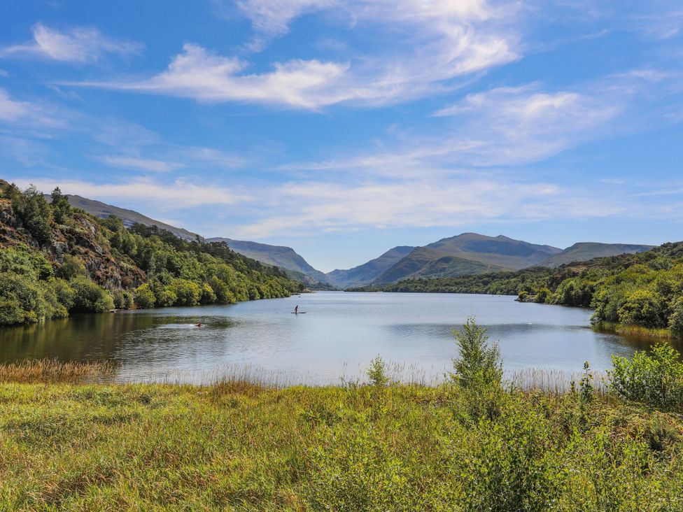 A lake surrounded by trees and mountains at Emily Rose Cottage in Bangor