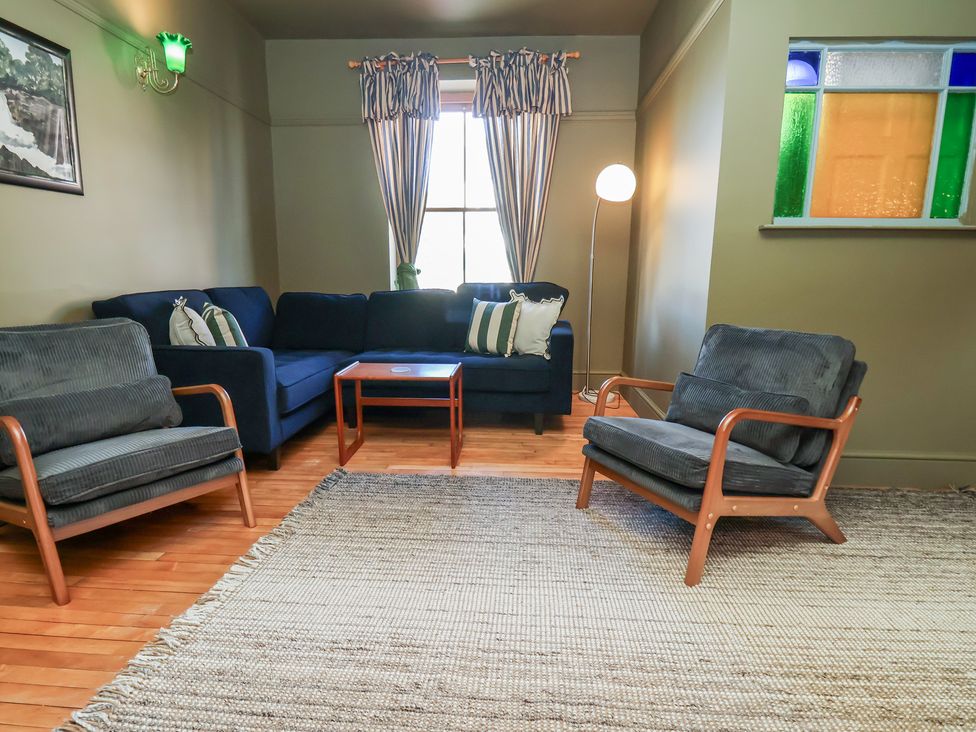 A living room with a sofa and armchairs at Mulgrave House in Hinderwell near Staithes