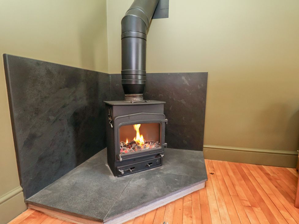 A stove with a flue in a living room at Mulgrave House Hinderwell near Staithes