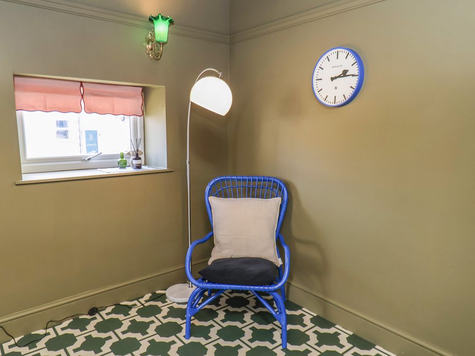 A snug with a blue chair and a lamp at Mulgrave House in Hinderwell near Staithes