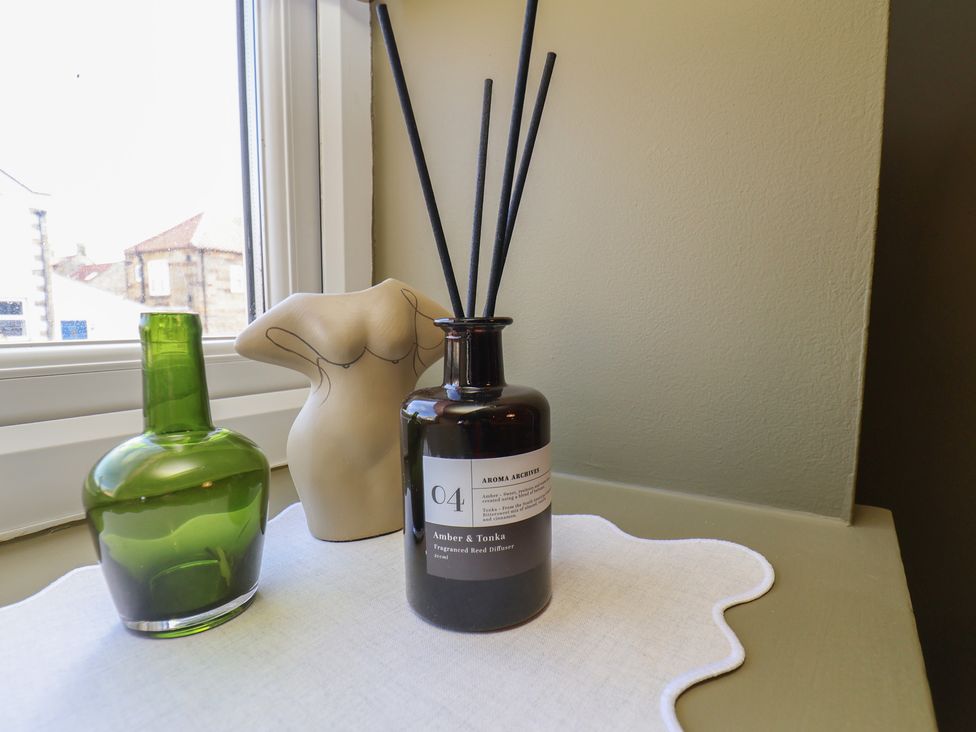 A table with a glass bottle and decorative object at Mulgrave House Hinderwell near Staithes