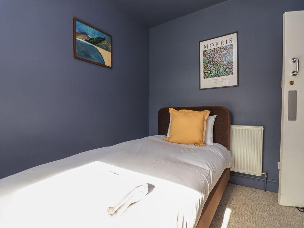 A bedroom with a bed and artwork on the wall at Mulgrave House Hinderwell near Staithes