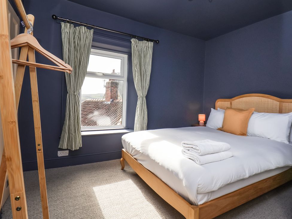 A bedroom with a bed and window at Mulgrave House in Hinderwell near Staithes