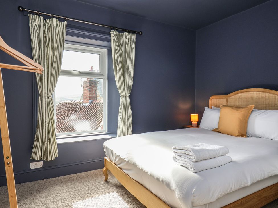 A bedroom with a bed and a window at Mulgrave House in Hinderwell near Staithes