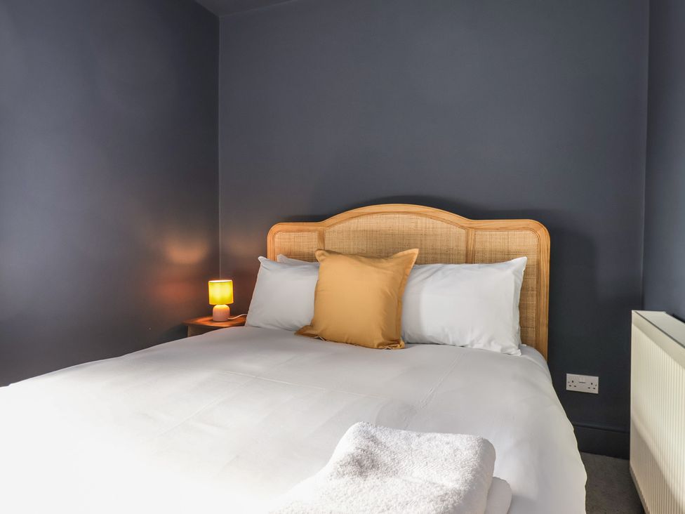 A bedroom with a bed and a bedside lamp at Mulgrave House Hinderwell near Staithes