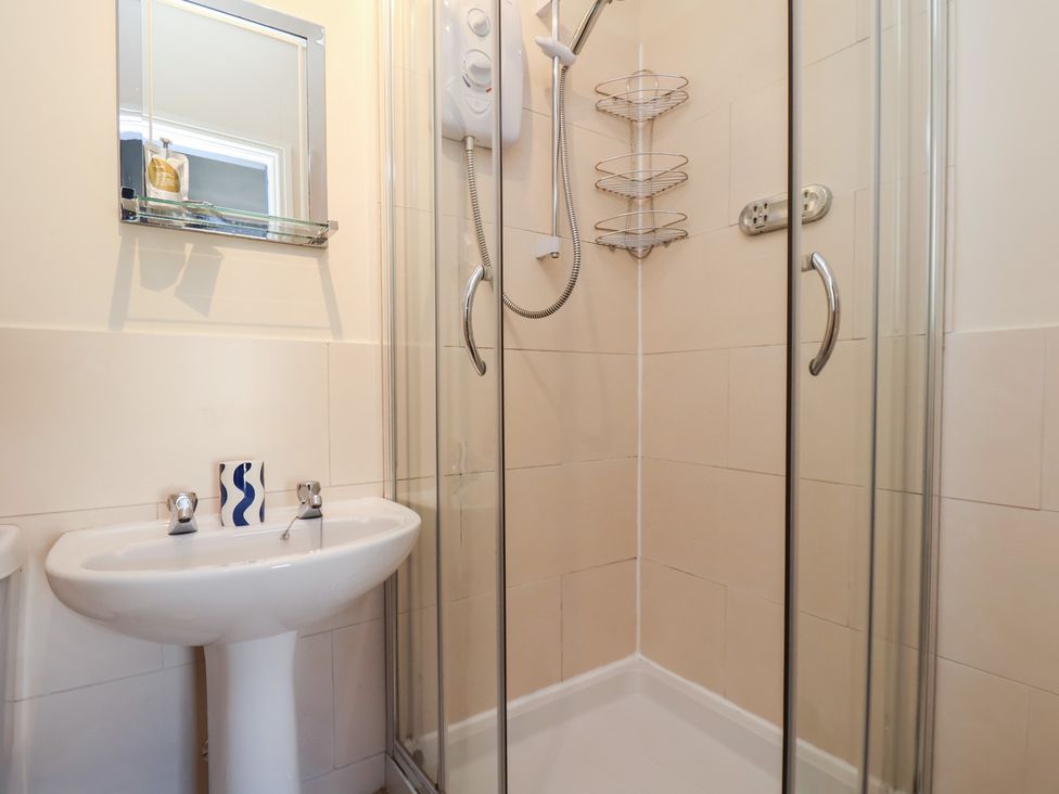 A bathroom with a shower and basin at Mulgrave House in Hinderwell near Staithes