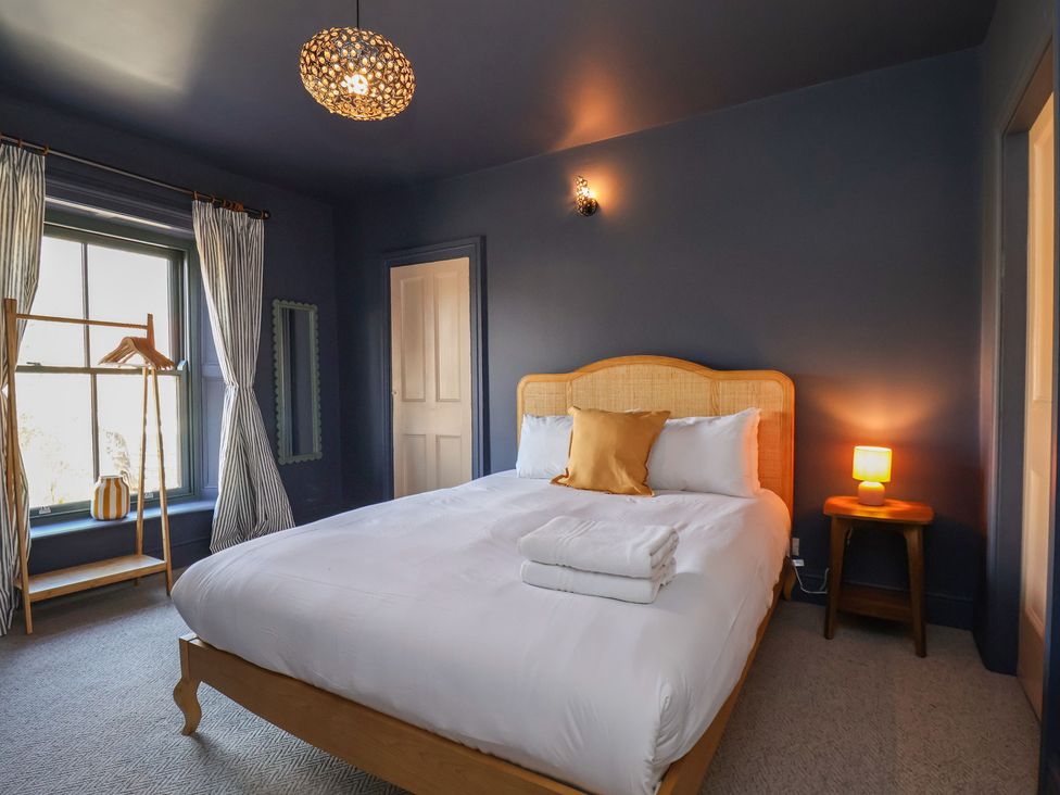 A bedroom with a bed and lamp at Mulgrave House Hinderwell near Staithes