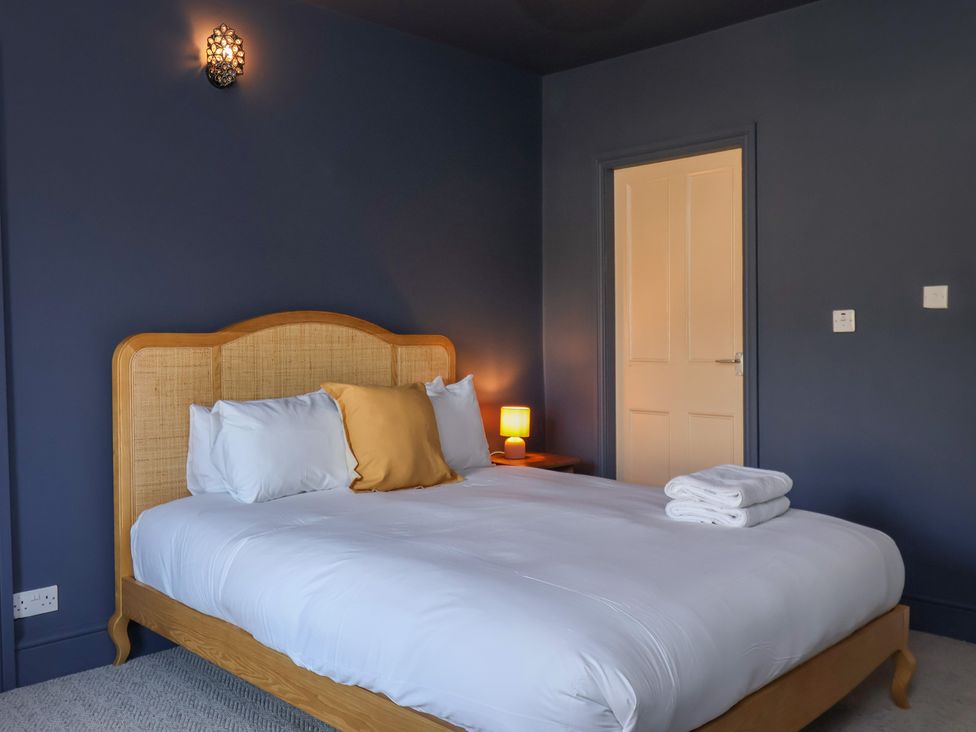 A bedroom with a bed and towels at Mulgrave House Hinderwell near Staithes