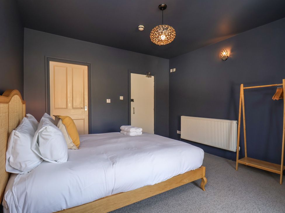 A bedroom with a bed and coat rack at Mulgrave House in Hinderwell near Staithes
