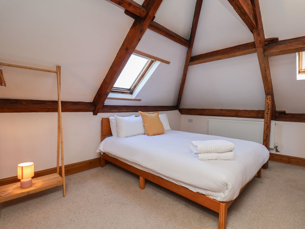 A bedroom with a bed and shelves at Mulgrave House in Hinderwell near Staithes