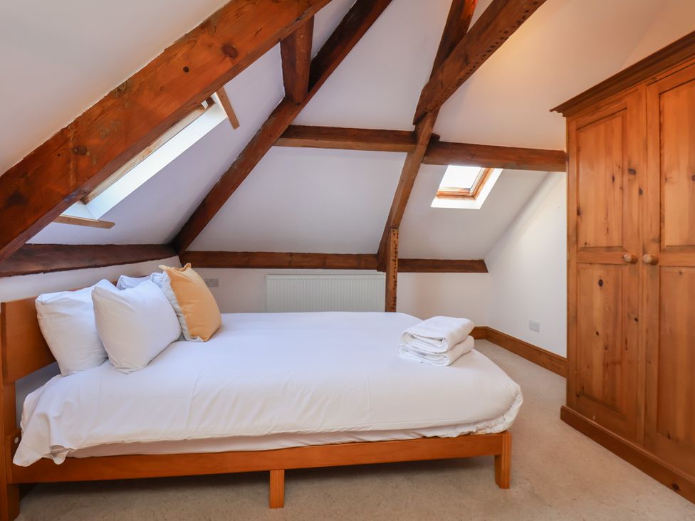 A bedroom with a bed and wardrobe at Mulgrave House Hinderwell near Staithes