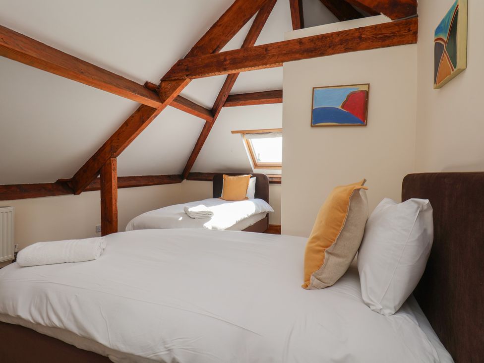 A bedroom with two beds and a window at Mulgrave House in Hinderwell near Staithes