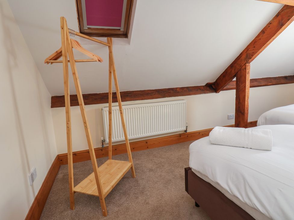 A bedroom with a clothes stand and a bed at Mulgrave House Hinderwell near Staithes