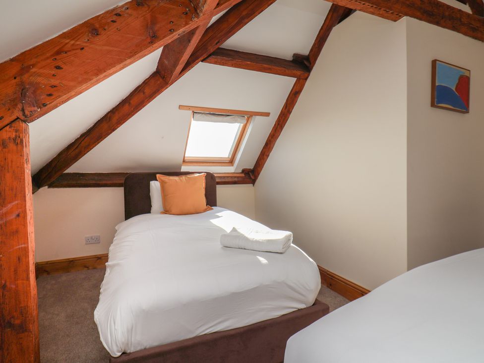 A bedroom with two beds and a window at Mulgrave House Hinderwell near Staithes