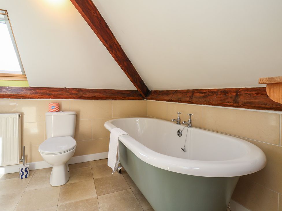 A bathroom featuring a bathtub and toilet at Mulgrave House in Hinderwell near Staithes