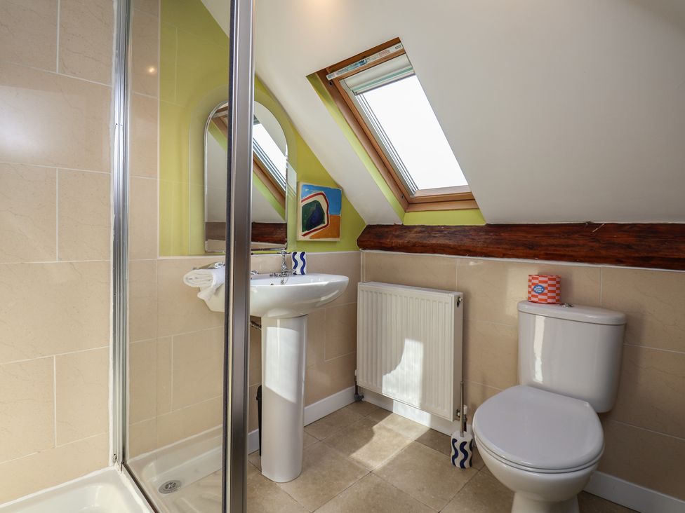 A bathroom with a sink, toilet and shower at Mulgrave House Hinderwell near Staithes