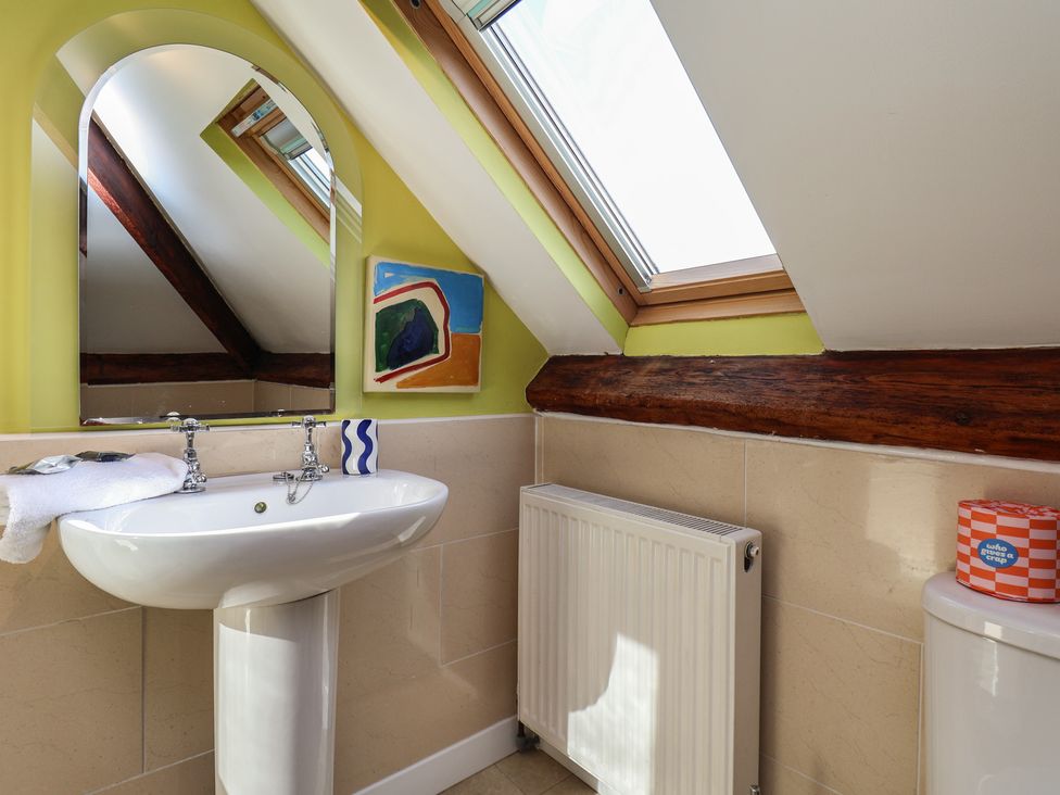 A bathroom with a sink and mirror at Mulgrave House in Hinderwell near Staithes