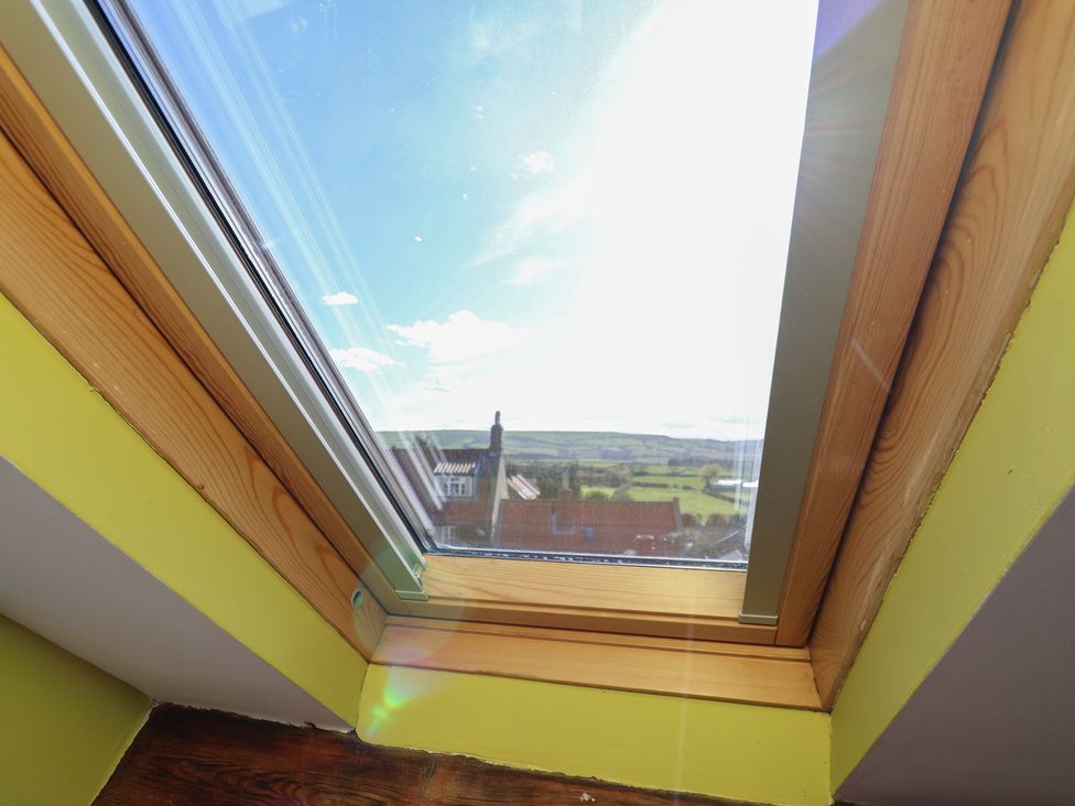 A window with a view of fields and rooftops at Mulgrave House in Hinderwell near Staithes