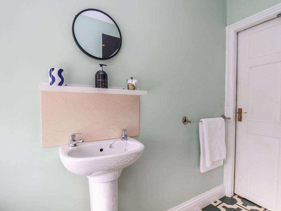 A bathroom with a sink and mirror at Mulgrave House in Hinderwell near Staithes