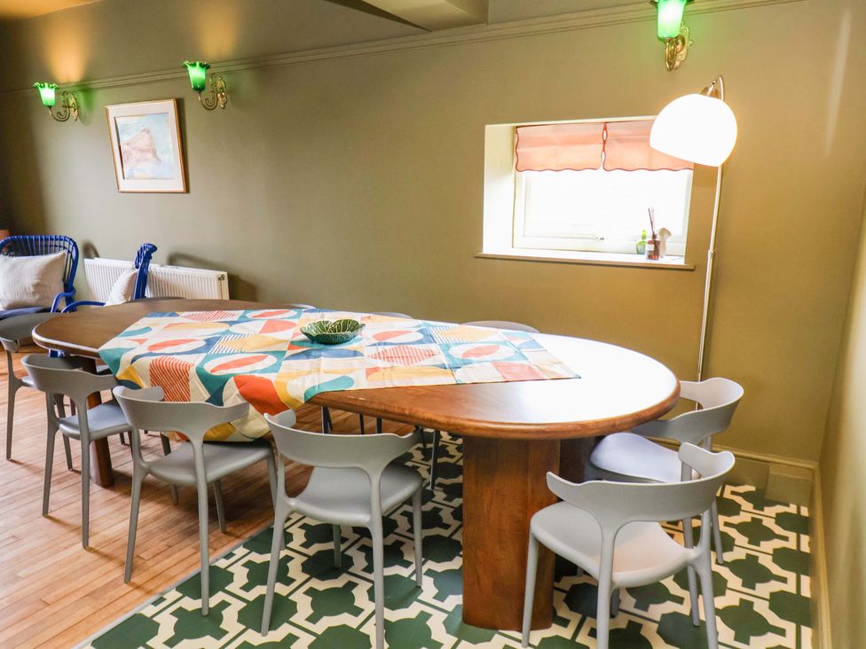 A dining room with a round table and chairs at Mulgrave House in Hinderwell near Staithes