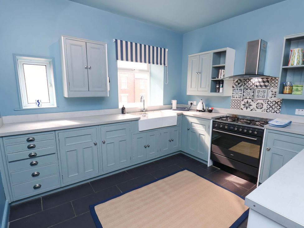A kitchen with cabinets and a sink at Mulgrave House in Hinderwell near Staithes