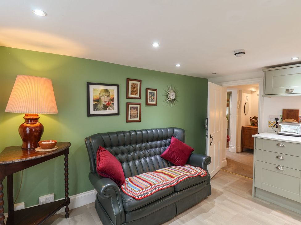 A living room with a sofa and lamp at Apartment at Mulgrave House Saltburn-by-the-Sea