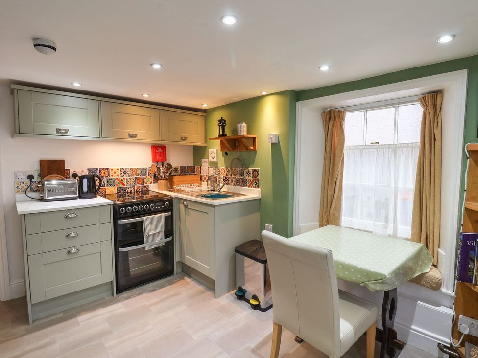 A kitchen with a table and kettle at Apartment at Mulgrave House Saltburn-by-the-Sea