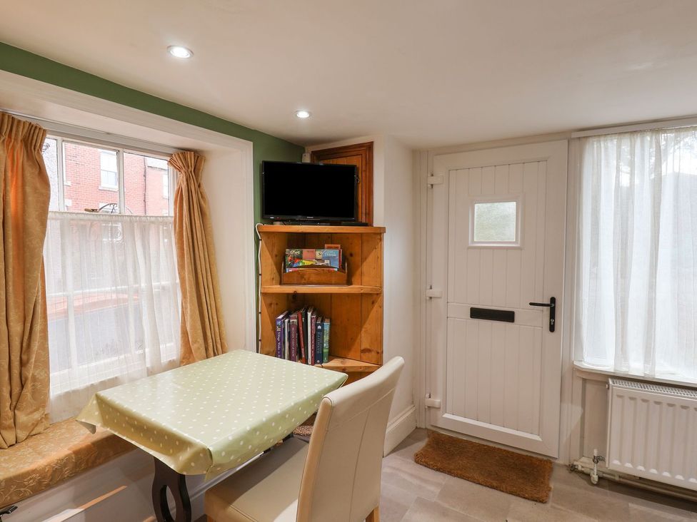 A kitchen with a table and chair near a window at Apartment at Mulgrave House Saltburn-by-the-Sea