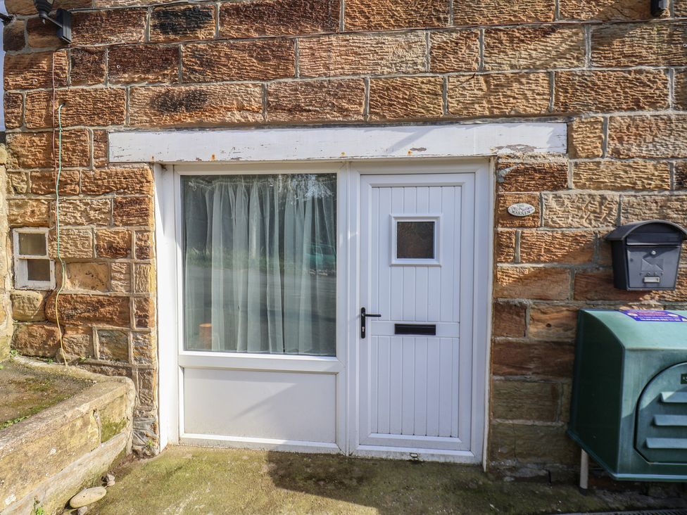 A door and window on a stone wall at Apartment at Mulgrave House Hinderwell near Staithes