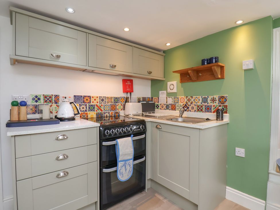 A kitchen with stove and sink at Apartment at Mulgrave House Hinderwell near Staithes