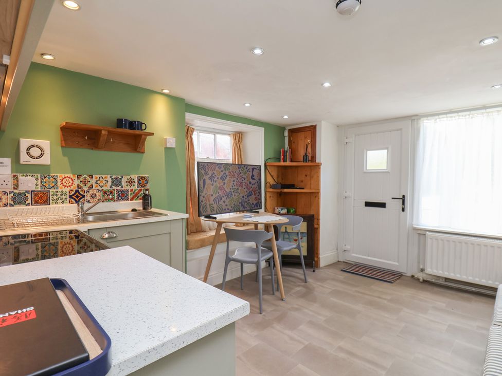 A kitchen with a table and chairs at Apartment at Mulgrave House Hinderwell near Staithes