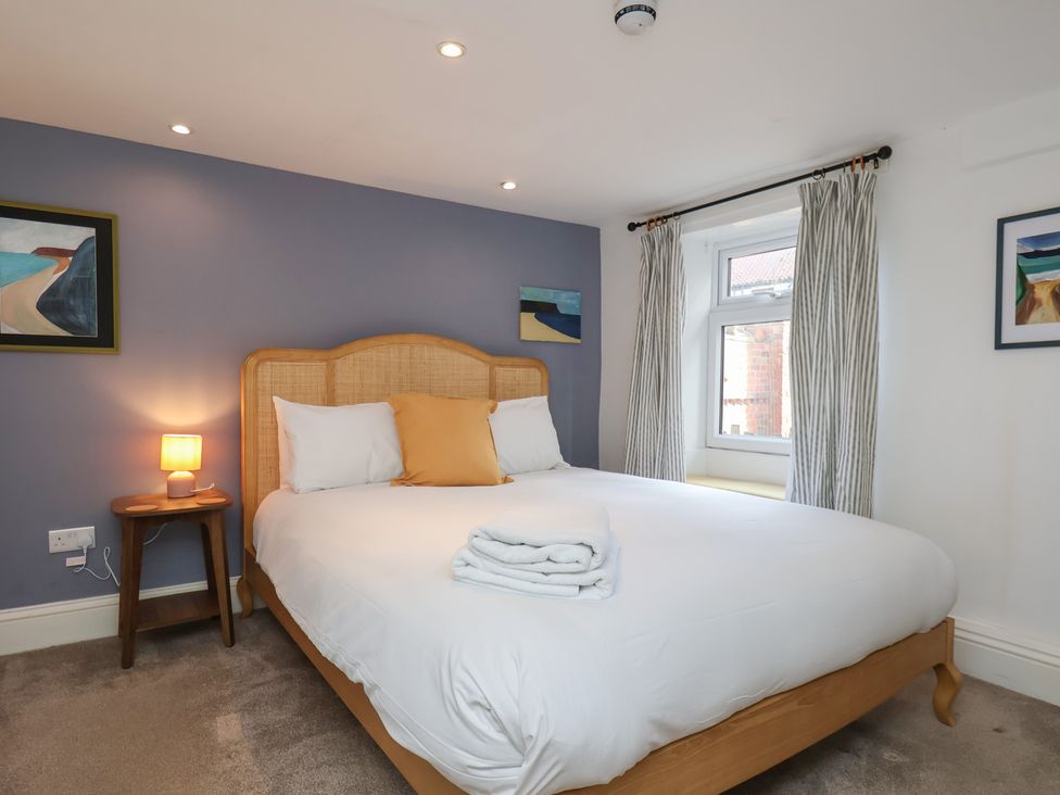 A bedroom with a bed and bedside table at Apartment at Mulgrave House Hinderwell near Staithes